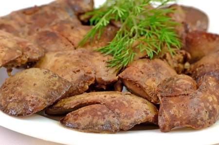 Close up cooked chicken liver on a white plateの写真素材