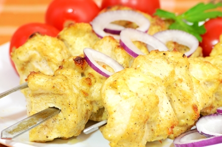 Chicken kebab with vegetables on a plateの写真素材