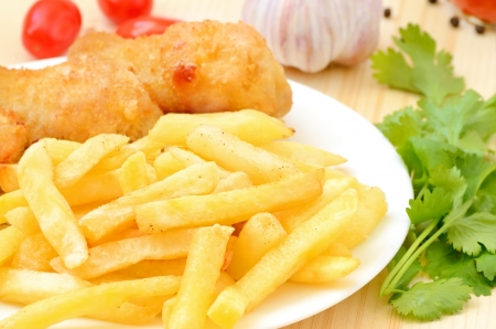 Fried chicken with french fries on the tableの写真素材