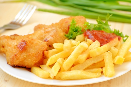 Fried chicken with french fries on the tableの写真素材