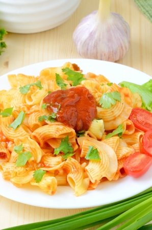 Pasta with tomato sauce on white plateの写真素材