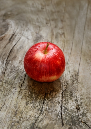 Red ripe apple on a wooden surfaceの写真素材