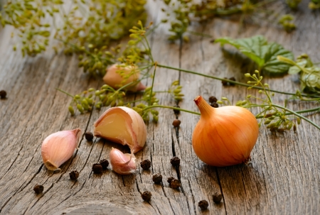 Onions, garlic, dill on a wooden garden tableの写真素材