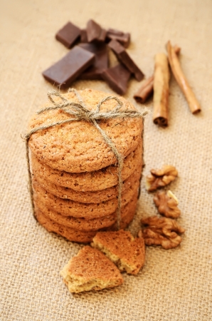 Oatmeal cookies, chocolate pieces and cinnamon sticksの写真素材
