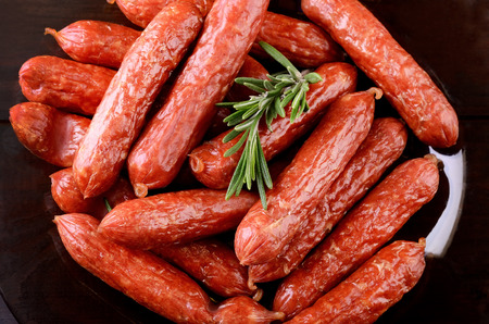 Smoked sausages on black plate, top view, close up の写真素材