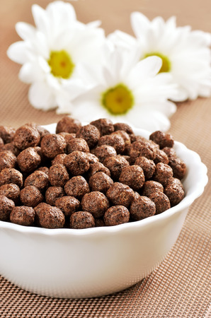 Cereal chocolate balls in white bowl の写真素材
