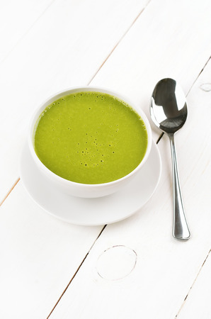 Spinach soup on wooden tableの写真素材