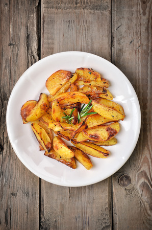 Baked potato wedges on white plate, top viewの写真素材