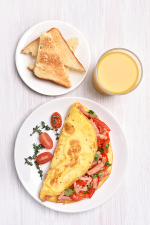 Omelette with vegetables and ham, top viewの写真素材