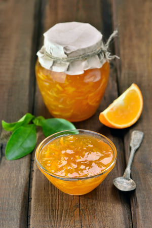 Jam from orange fruits on wooden tableの写真素材