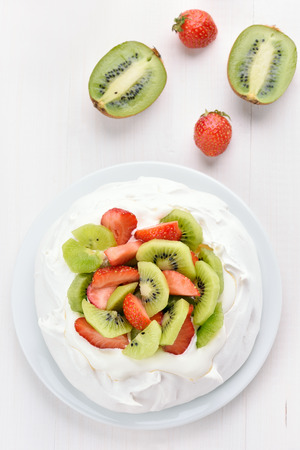 Meringue cake Pavlova with kiwi and strawberry, top viewの写真素材