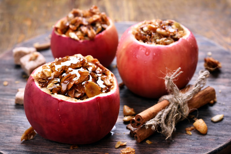Fruit dessert baked red apples stuffed with granolaの写真素材