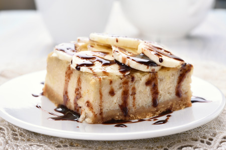 Dessert banana cheese cake, covered with chocolate sauce and slicesの写真素材
