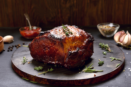 Juicy grilled pork, barbecue meat on wooden boardの写真素材