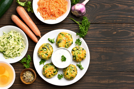 Healthy vegetable cutlet from carrot, zucchini, potato on wooden background with copy space. Diet food. Top view, flat layの写真素材