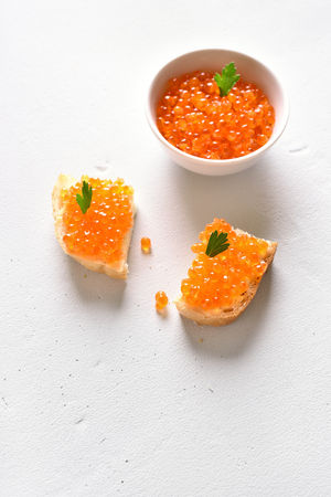 Sandwiches with red caviar on white stone background with copy space.の写真素材