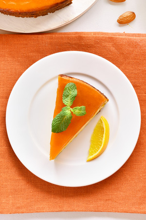 Healthy vegetarian dessert. Slice of pumpkin and orange pie. Traditional autumn dish. Top view, flat layの写真素材
