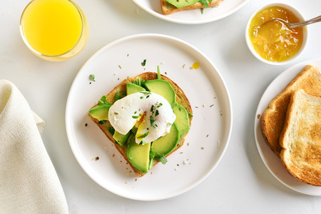 Breakfast. Poached eggs on toasted bread with vegetables. Top view, flat layの写真素材