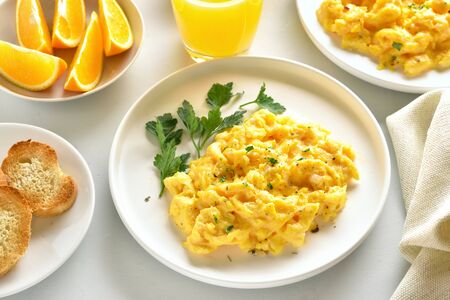 Scrambled eggs on plate over white stone background.の写真素材