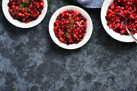 Beet salad in bowl. Healthy detox salad with beetroot, potato, carrot, pickles. Vegetarian vegan food over blue stone background with free space. Top view, flat layの写真素材