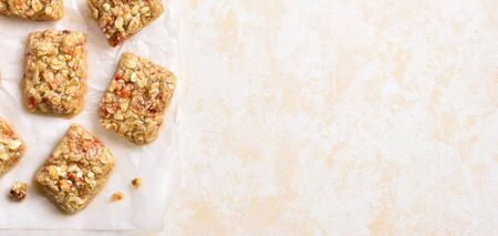 Honey no baked granola bar on paper over light stone background with free space. Natural healthy snack.の写真素材