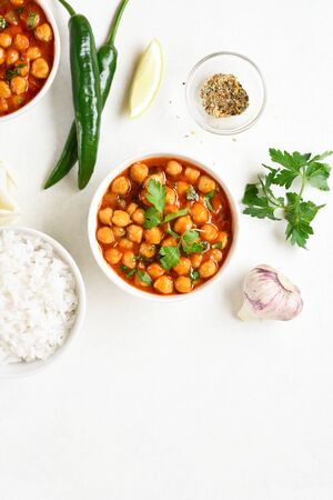 Indian style roasted chickpeas in bowl over white background with free text space. Vegetarian vegan food concept. Top view, flat layの写真素材