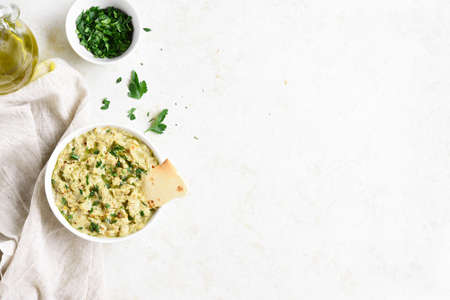 Baba ganoush (roasted eggplant dip) in bowl over light stone background with free text space. Vegetarian vegan food concept. Top view, flat layの写真素材