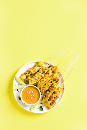 Grilled chicken skewers served with peanut dipping sauce. Chicken satay with peanut sauce. Tasty...
