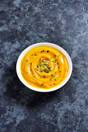Pumpkin puree in bowl over blue stone background with free text space. Healthy diet food concept.の写真素材