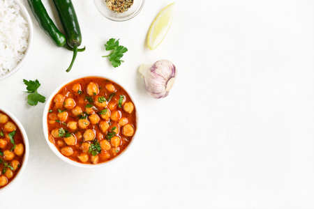 Indian style roasted chickpeas in a bowl over white background with free text space. Vegetarian vegan food concept. Top view, flat layの写真素材