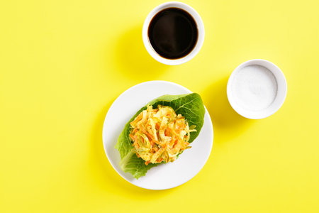 Diep fried vegetable in asian style. Japanese kakiage tempura. Yellow background with free text space, top view, flat layの写真素材