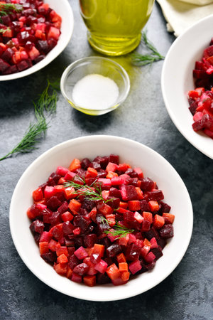Beet salad in bowl. Healthy detox salad with beetroot, potato, carrot, pickles on blue stone background.の写真素材