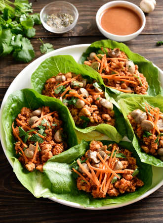 Asian minced meat lettuce wraps on wooden table. Close up viewの写真素材