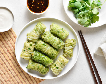 Chinese style stuffed cabbage rolls over white stone background. Top view, flat layの写真素材