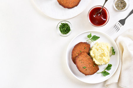 Meatloaf with mashed potato on plate over white background with free text space. Top view, flat layの写真素材