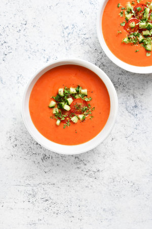 Gazpacho soup in bowl over light stone background with free text space. Cold tomato soup. top view, flat layの写真素材