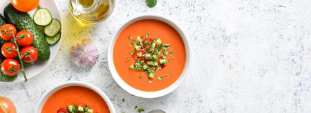 Gazpacho soup in bowl over light stone background with copy space. Cold tomato soup. top view, flat layの写真素材