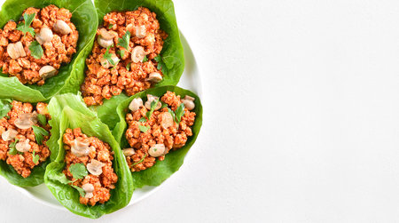 Thai style minced meat lettuce cups on white background with copy space. Top view, flat layの写真素材