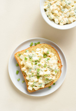 Egg salad sandwich on plate over light background. Top view, flat layの写真素材