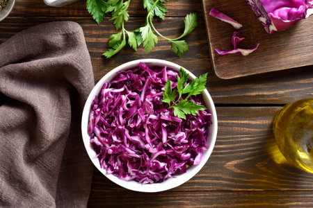 Red cabbage in bowl over wooden background. Top view, flat layの写真素材