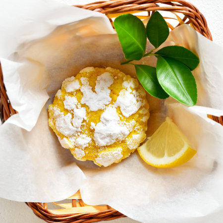 Homemade baked citrus cookies with lemon in bread basket on white background. Top view, flat layの写真素材