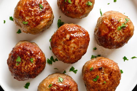 Close up view of cutlets from minced meat on white plate. Top view, flat lay