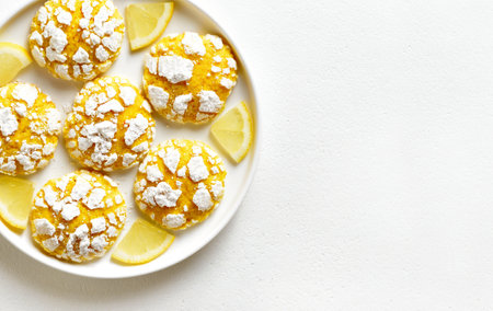 Close up view of healthy lemon crinkle cookie on plate over white stone background with copy space. Top view, flat layの写真素材