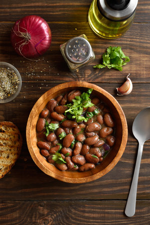 Stewed red beans in bowl on wooden table. Top view, flat layの写真素材