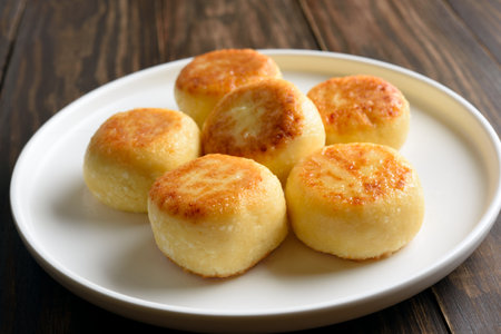Cheesecakes from cottage cheese (syrniki or curd fritters) on wooden background. Healthy diet food concept. Close up viewの写真素材