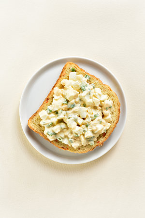 Egg salad sandwich on plate over light background with free space. Top view, flat layの写真素材