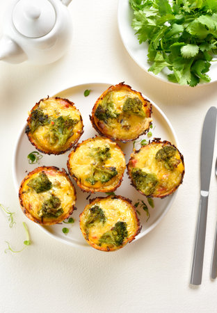 Breakfast egg muffins cups on plate on light background. Tasty meal for easy breakfast or lunch. Top view, flat layの写真素材