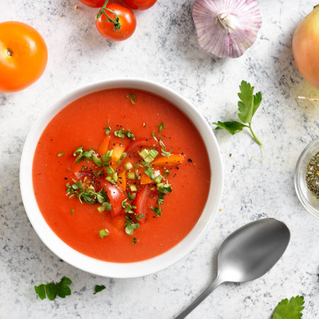 Gazpacho soup in bowl over light stone background. Cold tomato soup. Top view, flat layの写真素材