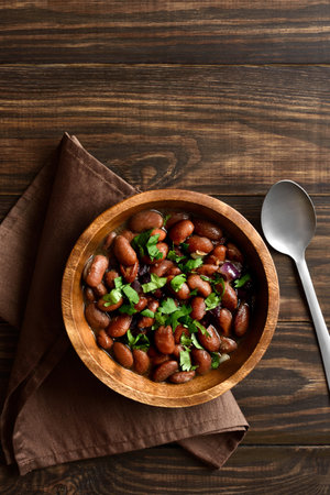 Baked beans in bowl on wooden background with free space for text. Top view, flat layの写真素材