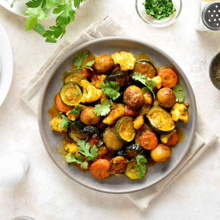 Vegetarian stew with mixed vegetables on plate over light background. Top view, flat layの写真素材
